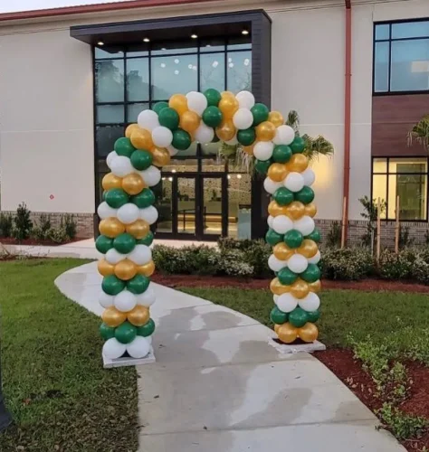 goldwhite+and+green+balloon+arch+outside+over+a+sidewalk-1920w